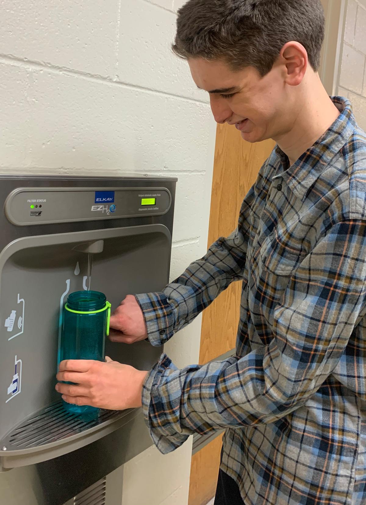Adult resident using a water refill station